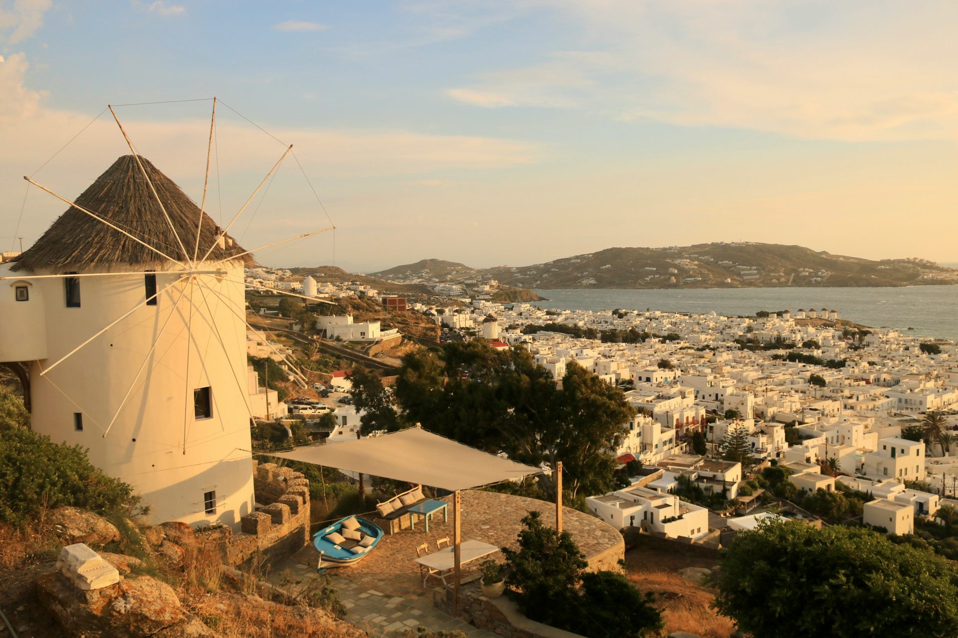 cyclades islands - The 8 Best Cyclades Islands to Visit This Summer A windmill overlooking a seaside village in Mykonos, Greece