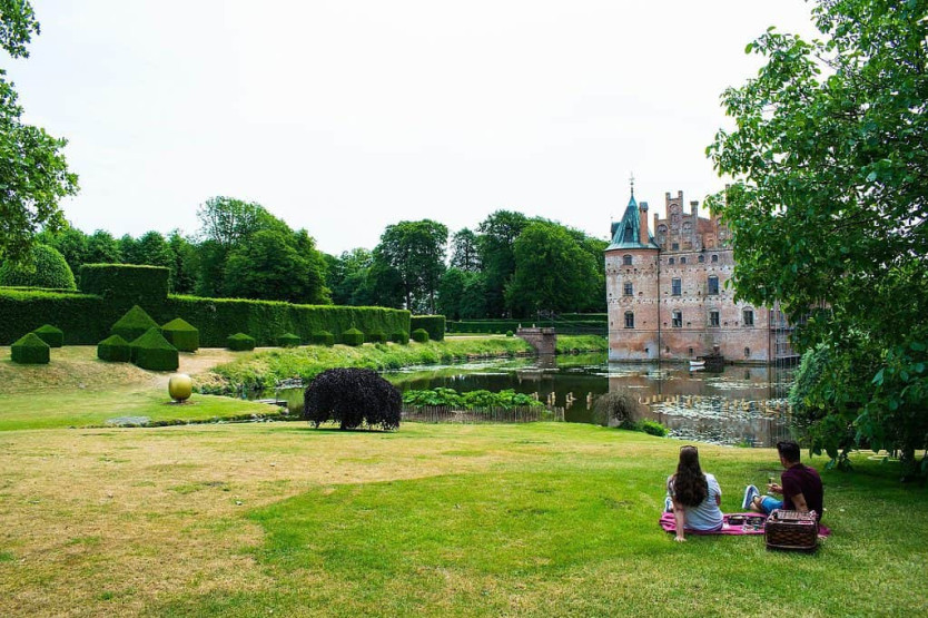 Enjoying a pick nick in the garden at Egeskov Castle, Fyn, Denmark