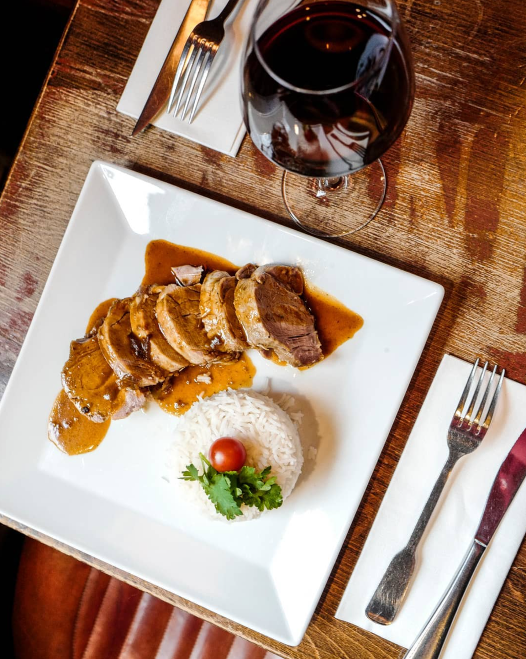 restaurants near major attractions in Paris - Good Restaurants Near Major Attractions in Paris A filet mignon of pork confit, rosemary jus and basmati rice for lunch at Carmine Cafe in Paris, France.